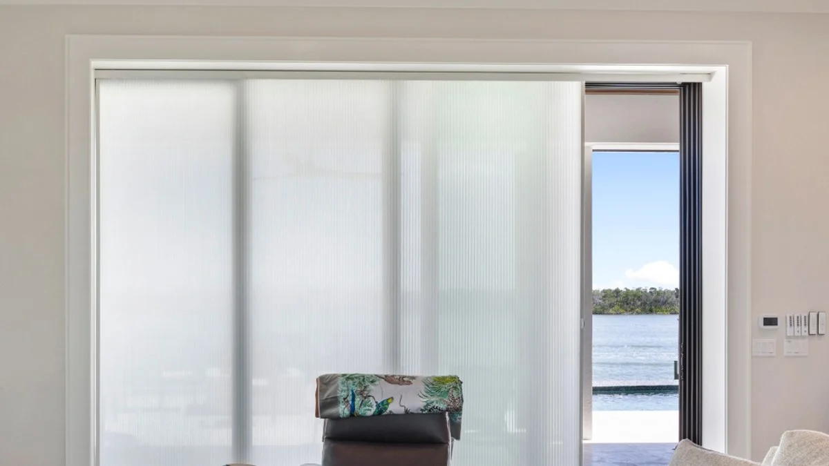 Wide living room glass planned around view, stack, and daily access