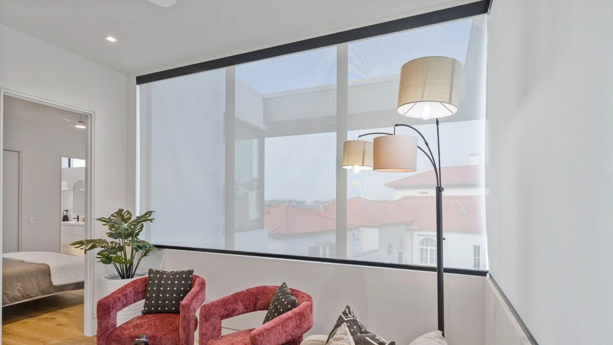 Blackout shade lowered across a broad Southwest Florida window