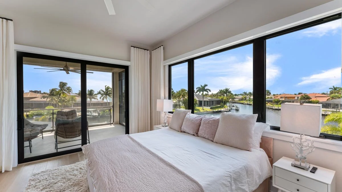 Cape Coral bedroom designed around bright canal-side glass