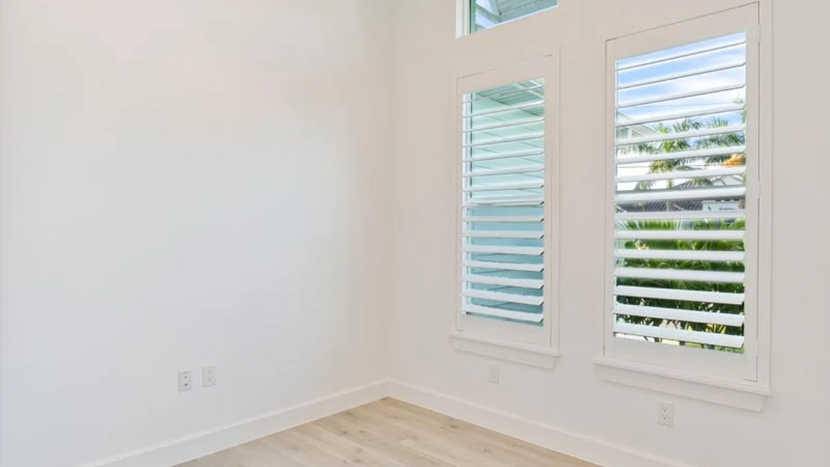 White shutters fitted to a narrow waterfront window