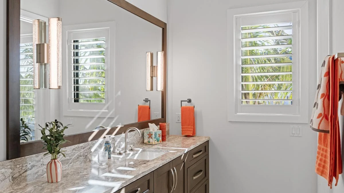 Bathroom plantation shutters aligned across multiple windows