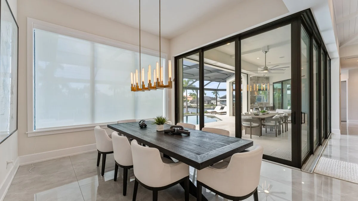 Roller shades positioned across a waterfront dining-room slider