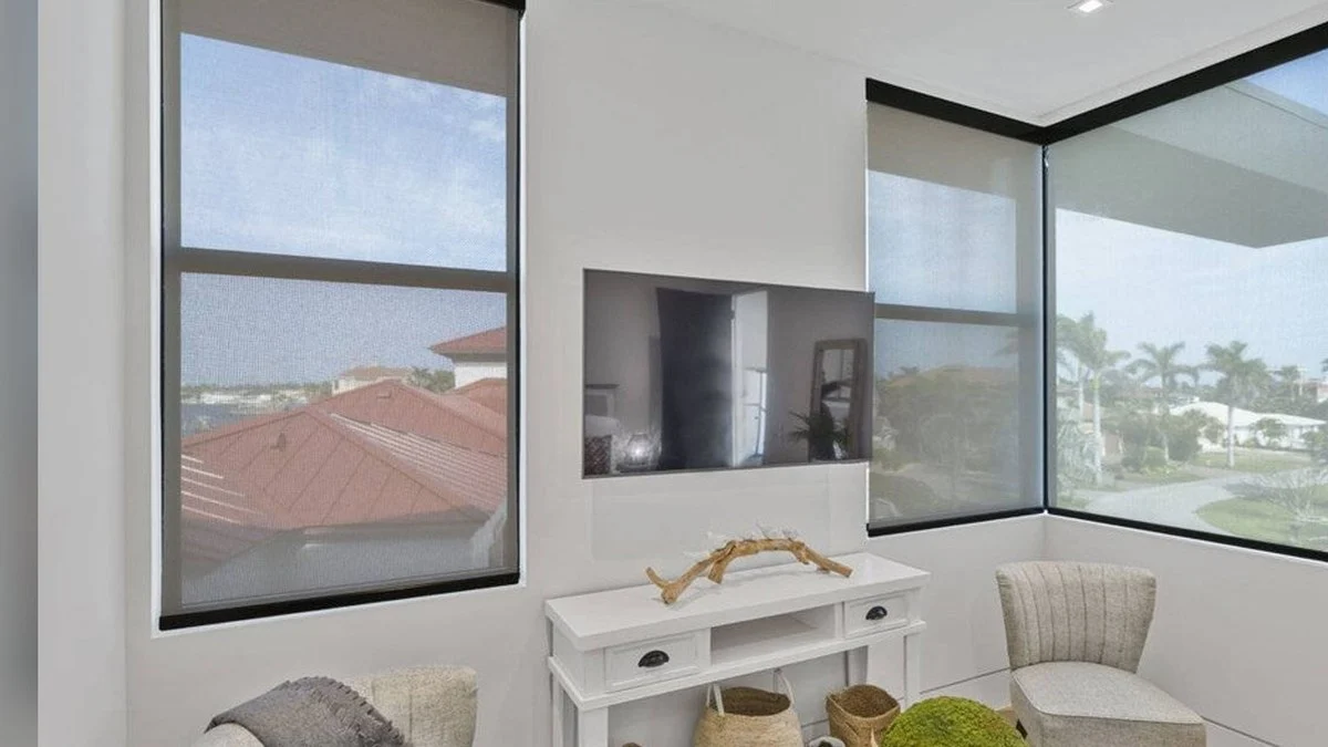 Exterior screen shade lowered across a covered opening