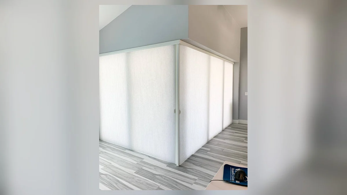 Vertical blind slats adjusted for privacy and coastal glare