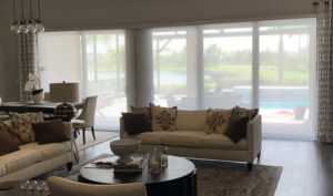 Light-filtering window treatments behind living-room seating