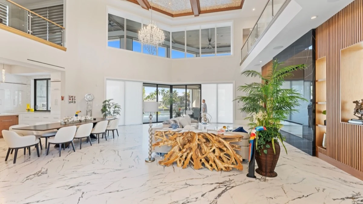 HoneycombSpan honeycomb shades retracted beside oversized sliding glass doors in a Southwest Florida home