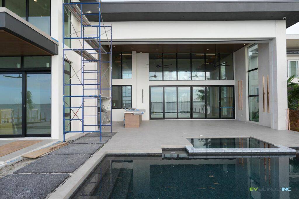 Motorized roller shades on large window treatments by EV Blinds