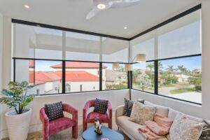 Modern living room featuring motorized roller shades that offer effortless, smart-control privacy and light management
