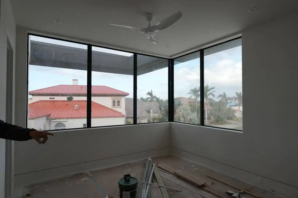 Modern living room featuring motorized roller shades that offer effortless, smart-control privacy and light management