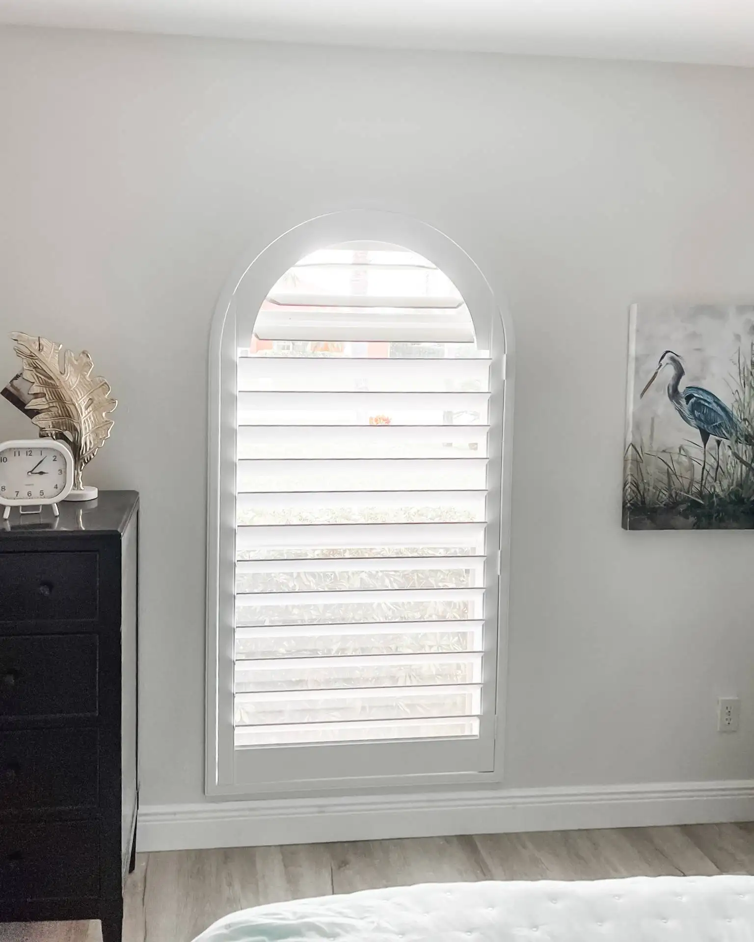 Plantation Shutters for arched windows in bedrooms in Pelican Bay