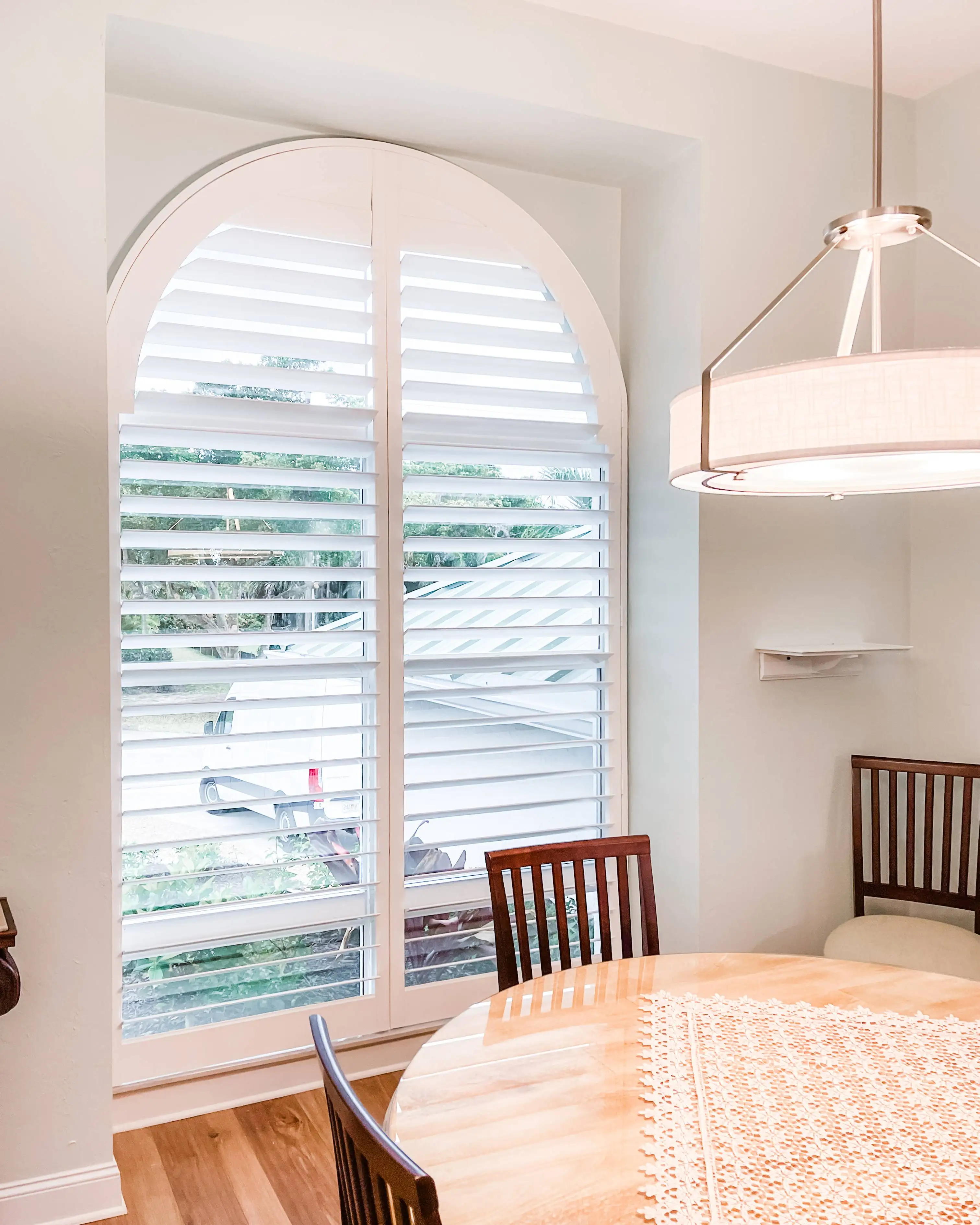 Plantation Shutters for arched windows in dining room in North Fort Myers