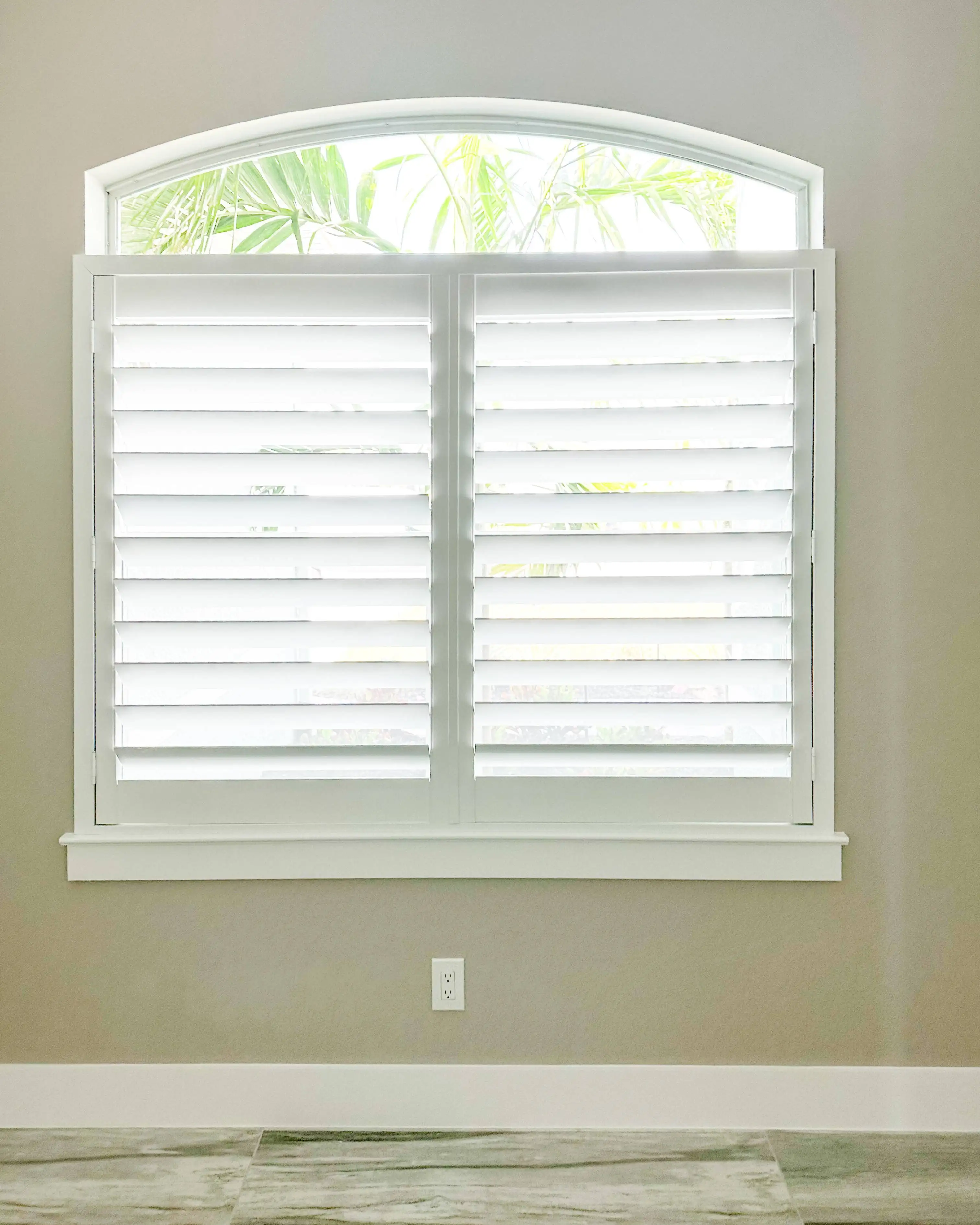 Plantation Shutters for arched window in living room in Naples