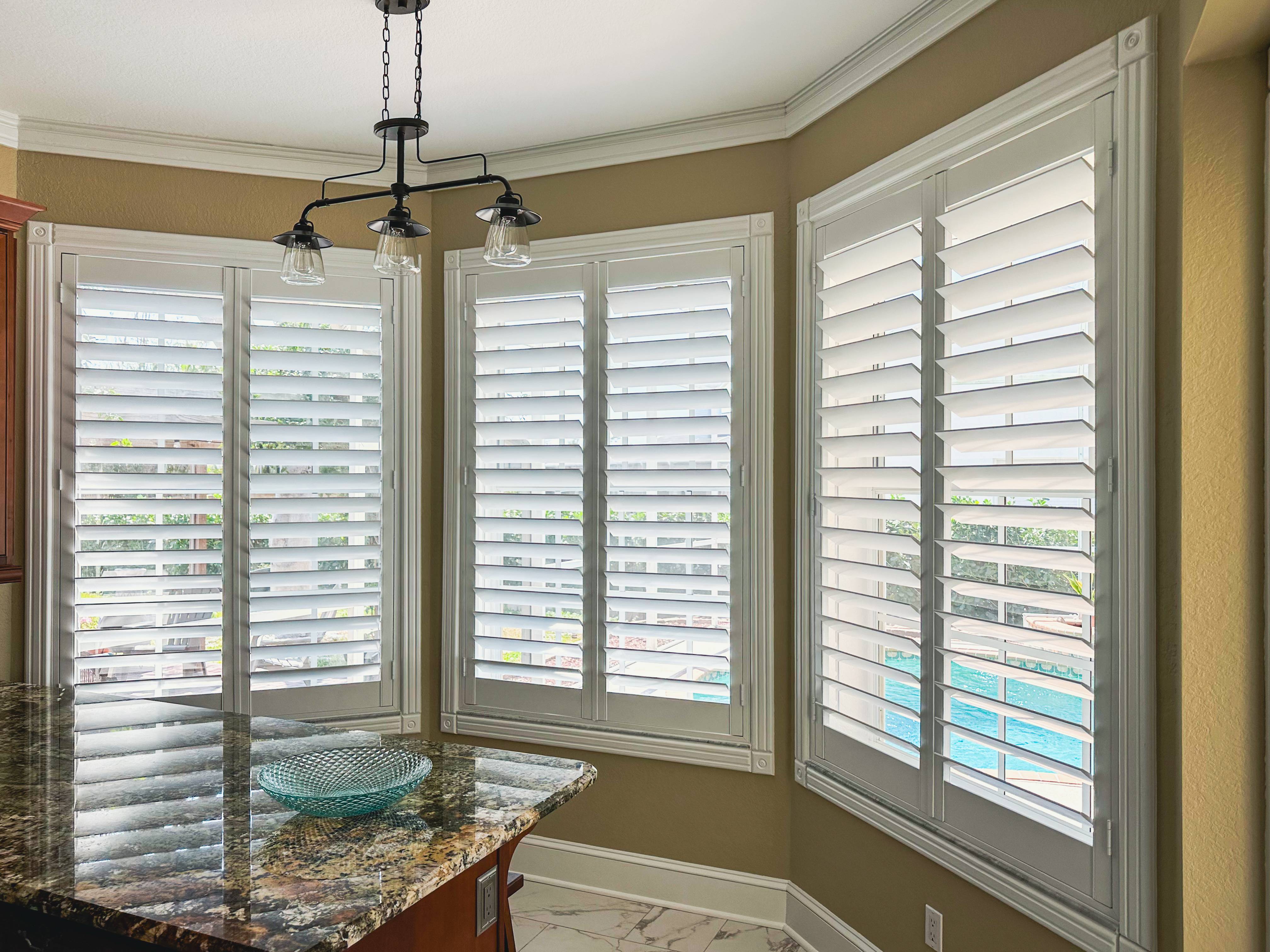 Plantation Shutters for bay window in living room in Cape Coral