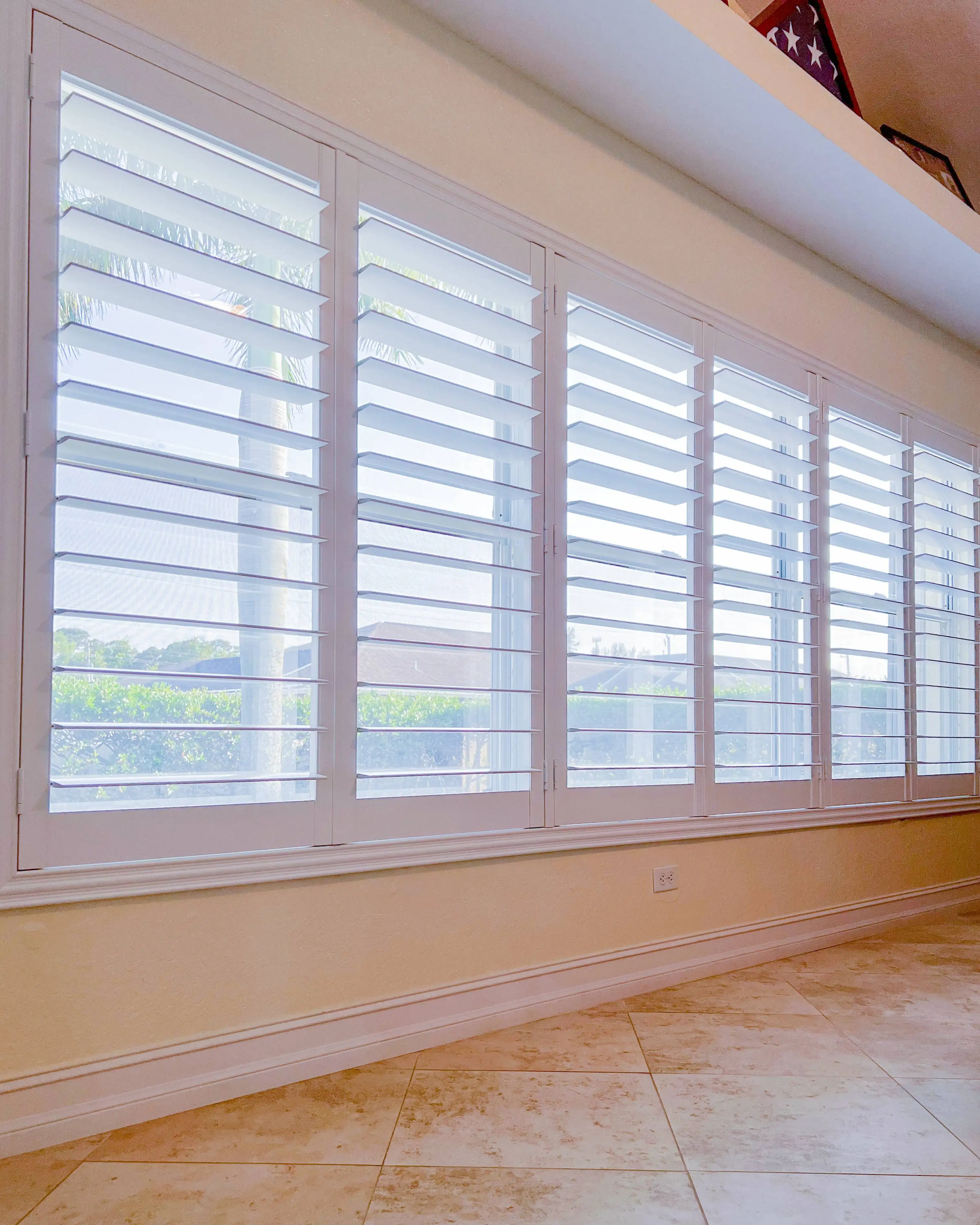 Plantation Shutters for large windows in living room in Pelican Bay