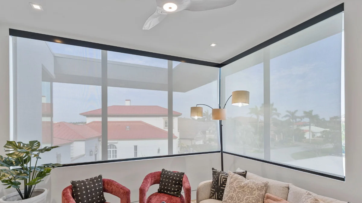 Open light-filtering roller shades preserving a living room view