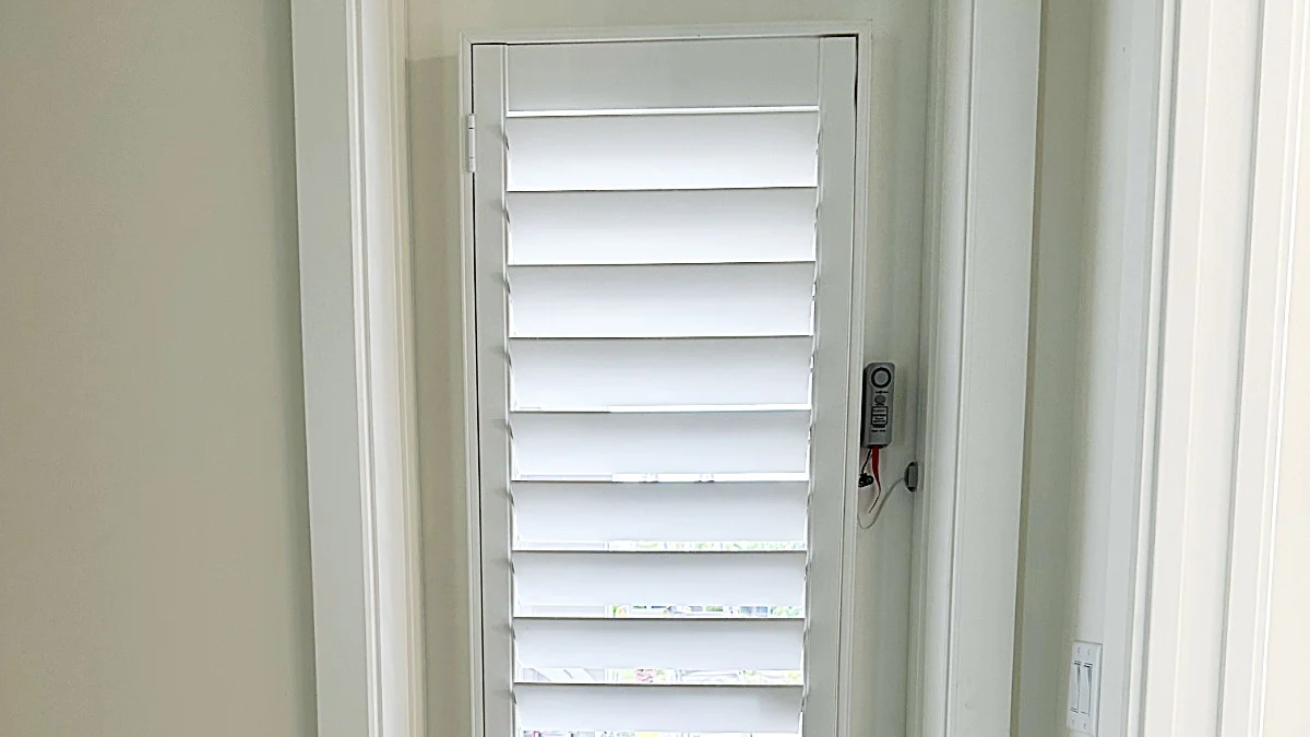 White shade custom fitted to a small door window