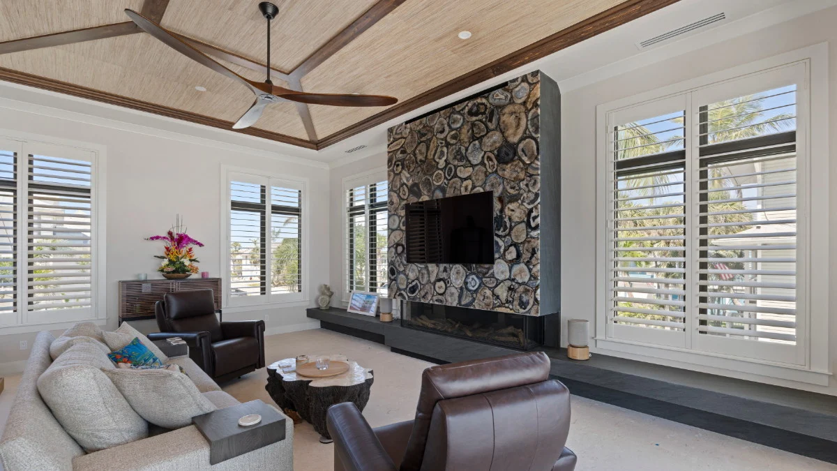 Plantation shutters providing adjustable glare control near a living room television
