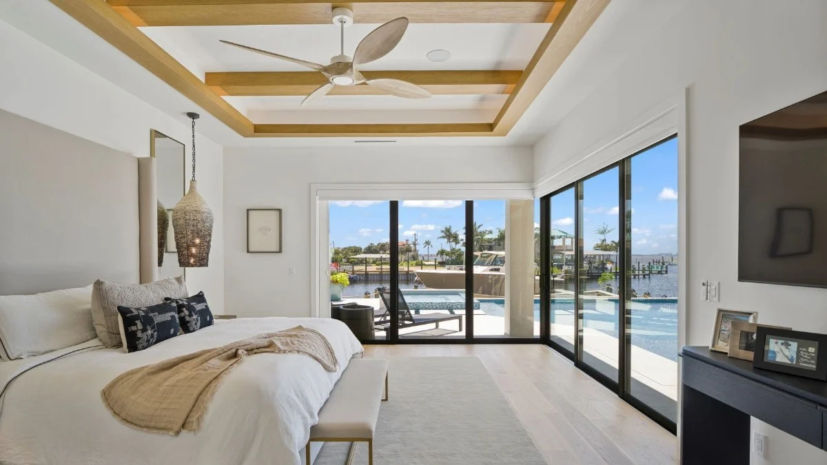 Cellular sliding door shades framing a Punta Gorda bedroom view