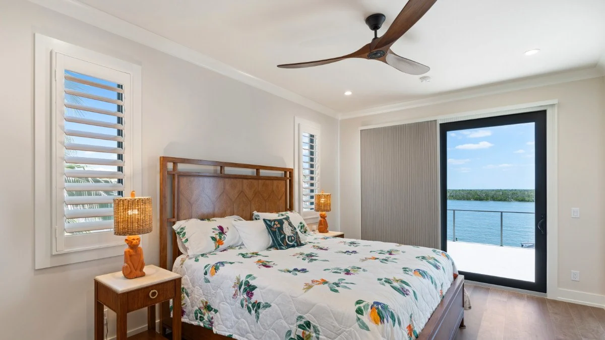 Opaque cellular slider shades reducing visible interior light near the coast