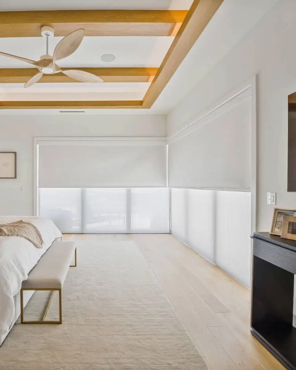 Double Shades featuring light filtering cellular honeycomb slider under motorized smart roller shade with blackout fabric for ultimate light control