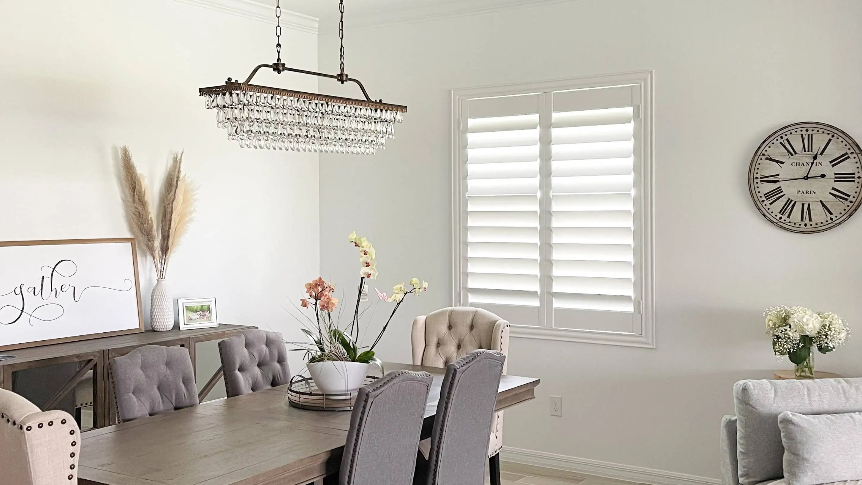 Custom wood blinds and shutters closed for windows installed in a SWFL living room